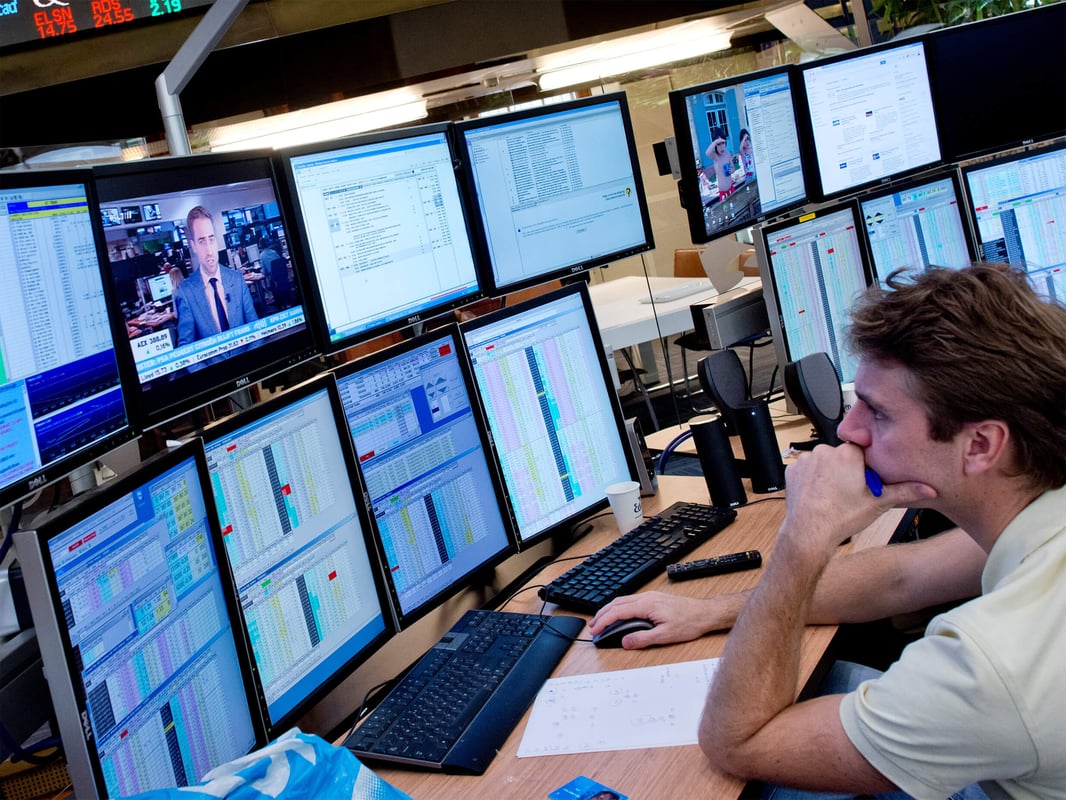 analyst looks at screens with marketdata