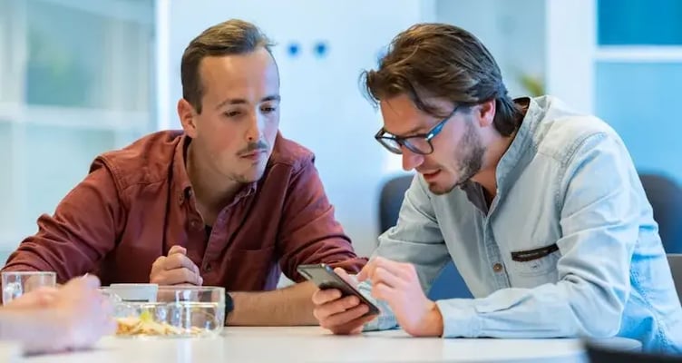 colleagues looking at a phone