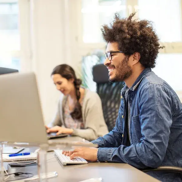Man and women working behind their computer